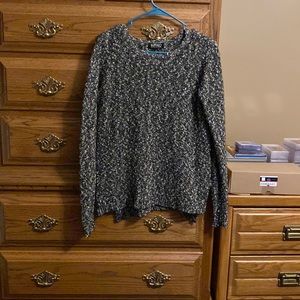 Woman’s charcoal gray sweater.